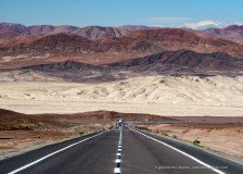 Panamerican Highway or Ruta 5 passing through colorful mountains of the Atacama desert near Chañaral, Chile