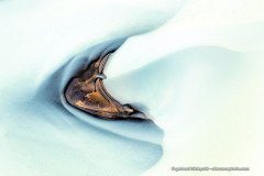 Abstract photo of of volcanic sand island in a glacial stream in Iceland