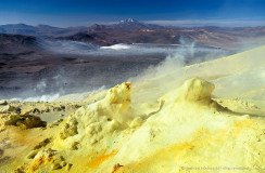 Sulfur fumaroles at the top of volcano Lastarria. Lullaillaco in the background.