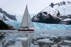 Yacht Icebird sailing along the glacier front of Pia fjord, Tierra del Fuego Patagonia