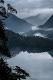 Fog, clouds and reflections. A rainy day in Alerce Andino National Park. Lake Sargazo.