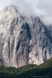 Vertical granite rock face of Cerro Trinidad with Alerce forest, Valle Cochamo