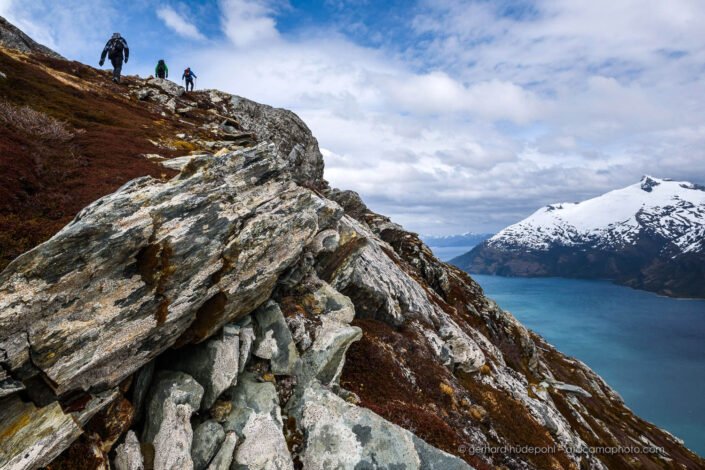 Hikers on top of a mountain with spectacular view at Garibaldi Fjord, Beagle Channel Patagonia Chile