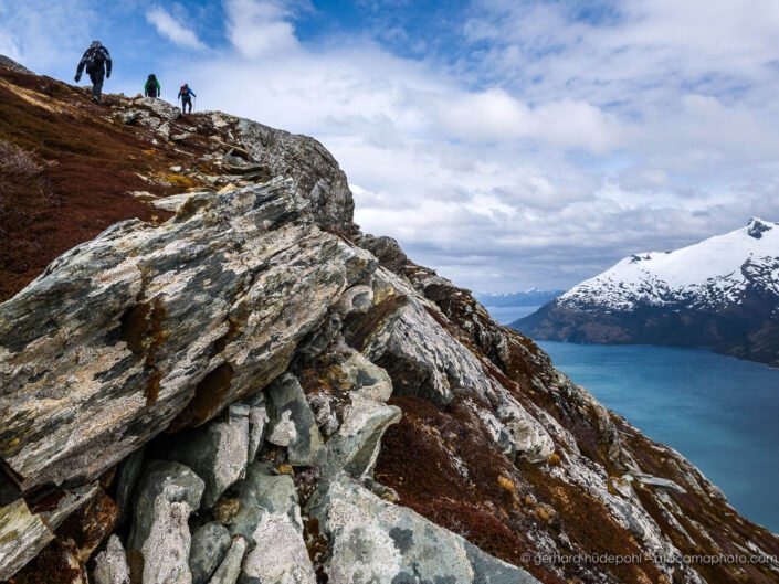 Hikers on top of a mountain with spectacular view at Garibaldi Fjord, Beagle Channel Patagonia Chile