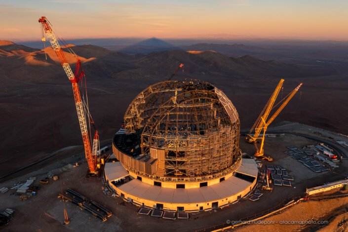 ELT on Cerro Armazones at sunset in May 2024, with shadow of mountain at the horizon