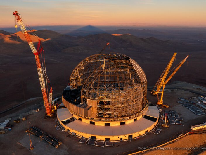 ELT on Cerro Armazones at sunset in May 2024, with shadow of mountain at the horizon