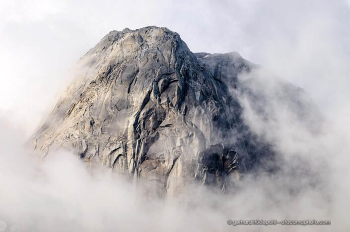 Granite dome of Cerro Trinidad sticking out of the clouds, Valle Cochamo