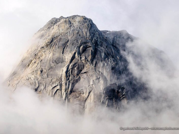 Granite dome of Cerro Trinidad sticking out of the clouds, Valle Cochamo