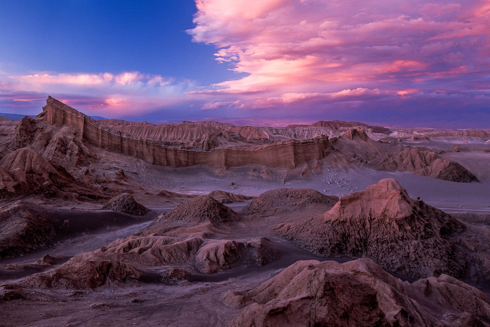 Red clouds over Valle de la Luna, dramatic sunset in Pedro de Atacama, Chile