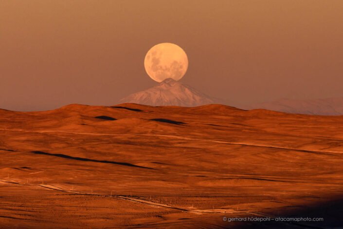 Full moon rising behind Lullaillaco volcano, at a distance of 190 km.