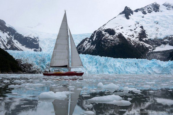 Yacht Icebird sailing along the glacier front of Pia fjord, Tierra del Fuego Patagonia